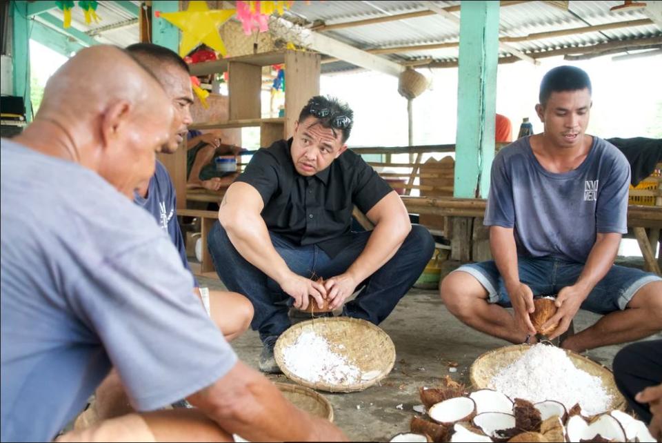 Concordia, 39, socialising with the inmates during mealtime at the Iwahig Prison and Penal Farm in Palawan, Philippines.