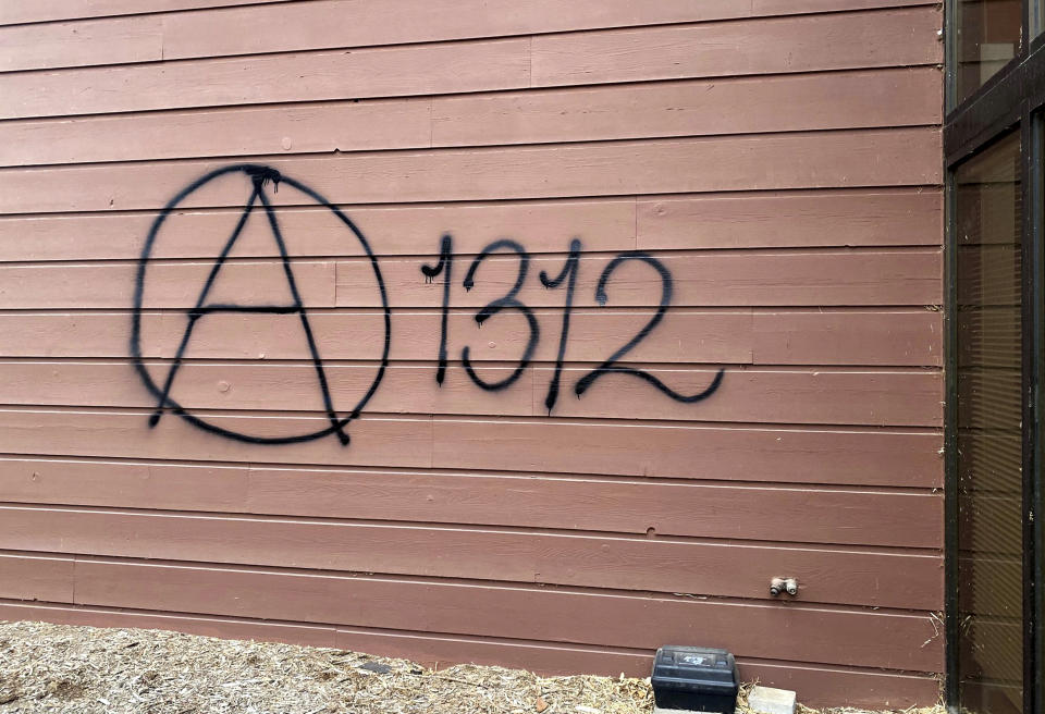 Threatening graffiti which reads "A 1312" is seen on the exterior of Wisconsin Family Action offices in Madison, Wis., on Sunday, May 8, 2022. The Madison headquarters of the anti-abortion group was vandalized late Saturday or early Sunday, according to an official with the group. (Alex Shur/Wisconsin State Journal via AP)