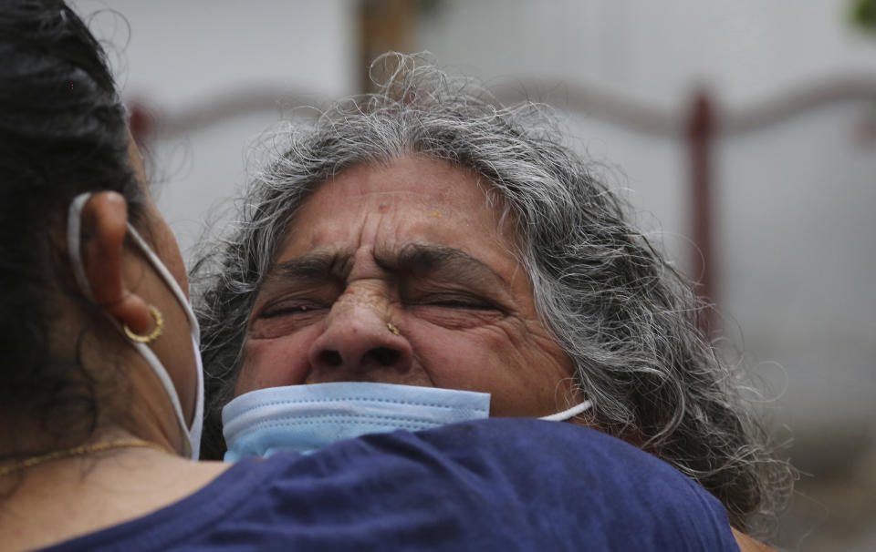 Mother of Rakesh Pandita, a politician who was killed late Wednesday, mourns at their residence in Jammu, India, Thursday, June.3, 2021. Assailants fatally shot the politician belonging to India’s ruling party in disputed Kashmir, police said Thursday, blaming separatist rebels for the attack. The unidentified assailants fired at Pandita late Wednesday in the southern town of Tral, where he was visiting a friend, police said. He was declared dead in a hospital. (AP Photo/Channi Anand)