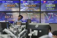 A currency trader watches monitors at the foreign exchange dealing room of the KEB Hana Bank headquarters in Seoul, South Korea, Wednesday, April 29, 2020. Asian stock markets gained Wednesday after France and Spain joined governments that plan to ease anti-virus controls and allow businesses to reopen. (AP Photo/Ahn Young-joon)