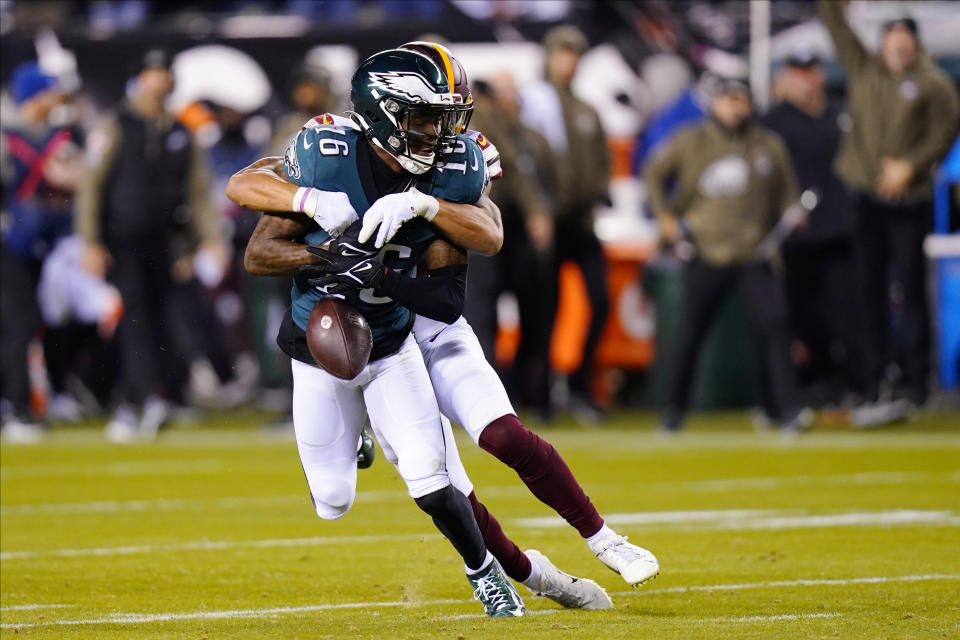 Philadelphia Eagles wide receiver Quez Watkins (16) fumbles the ball as he is tackled by Washington Commanders cornerback Benjamin St-Juste during the second half of an NFL football game, Monday, Nov. 14, 2022, in Philadelphia. (AP Photo/Chris Szagola)