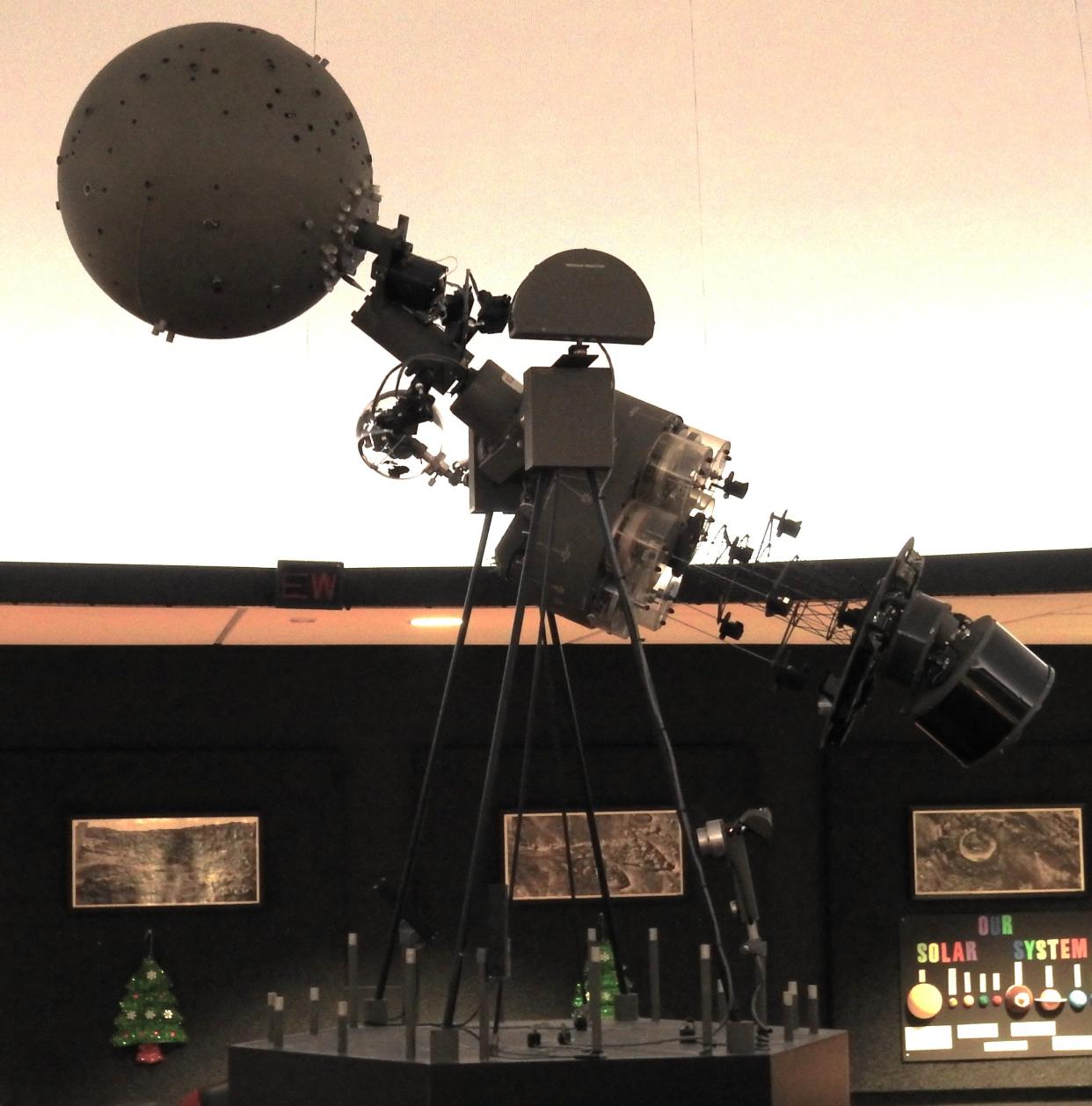 The projector of the Coshocton Planetarium at Coshocton High School with the dome images are displayed on in the background.