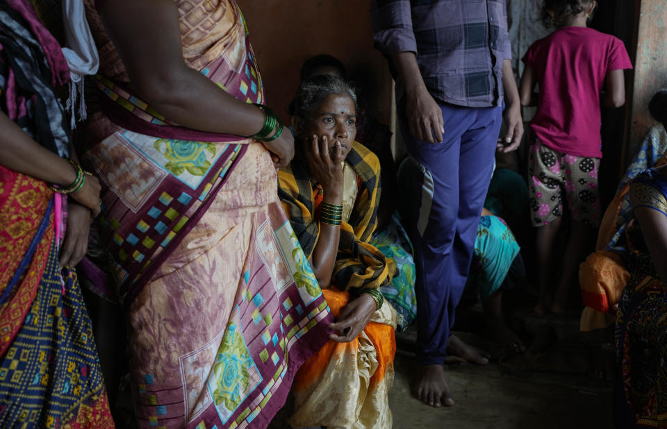 Family members of people trapped under rubble wait for news of rescue after a landslide washed away houses in Raigad district, western Maharashtra state, India, Thursday, July 20, 2023. While some people are reported dead many others feared trapped under piles of debris. (AP Photo/Rafiq Maqbool)