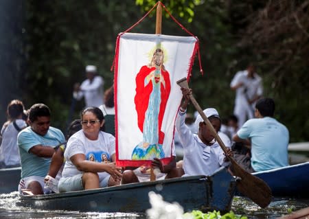 FILE PHOTO: Roman Catholic pilgrims travel as they accompany the statue of Our Lady of Conception during an annual river procession and pilgrimage along the Caraparu River in Santa Izabel do Para