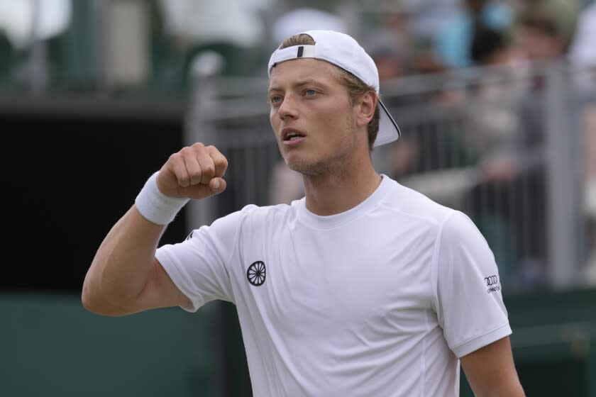 Tim van Rijthoven celebrates winning the first set against Nikoloz Basilashvili in a Wimbledon match July 1, 2022.