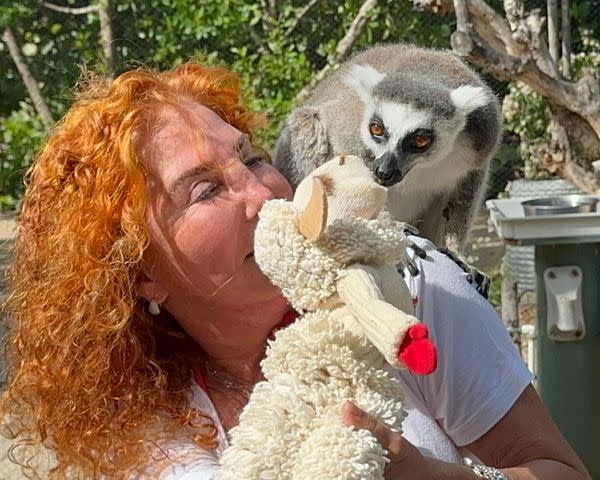 <p>Courtesy of Mallory Lewis</p> Mallory Lewis and Lamb Chop feed a lemur