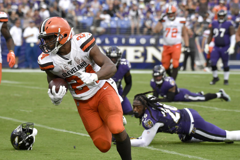 Cleveland Browns running back Nick Chubb (24) prepares to cross the goal line after avoiding several tackles from Baltimore Ravens defenders during the second half of an NFL football game Sunday, Sept. 29, 2019, in Baltimore. (AP Photo/Brien Aho)