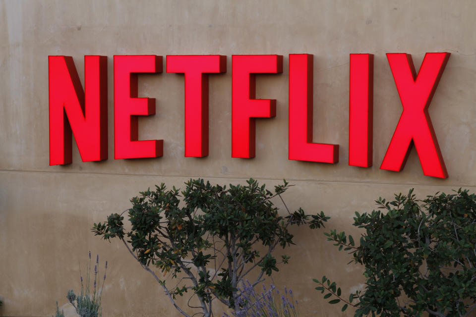 Red Netflix logo on a beige stucco wall.