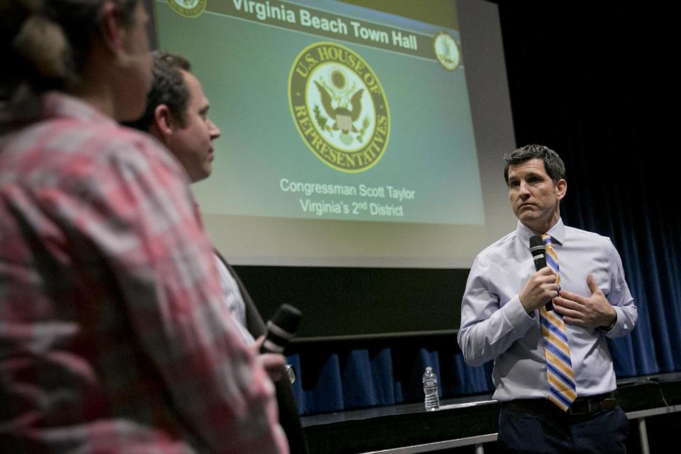 Rep. Scott Taylor answers a question by an audience member during a town hall meeting at Kempsville High School in Virginia Beach, Va., Monday, Feb. 20, 2017. (Kristen Zeis/The Virginian-Pilot via AP)