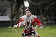 In this photo taken Saturday, April 4, 2020, Wicahpi Cuny, 14, a Dakota and Lakota tribal member, dances during a live streamed powwow from a park near her home, in Puyallup, Wash. The largest powwows in the country have been canceled or postponed amid the spread of the coronavirus. Tribal members have found a new outlet online with the Social Distance Powwow. They're sharing videos of colorful displays of culture and tradition that are at their essence meant to uplift people during difficult times. (AP Photo/Elaine Thompson)