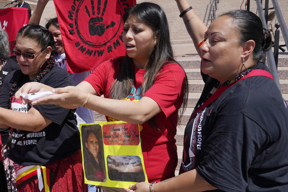 Nickie Saunders, center, of Tecumseh, Okla., releases a butterfly during ceremonies at the state Capitol on Missing and Murdered Indigenous Peoples Awareness Day, Friday, May 5, 2023, in Oklahoma City. (AP Photo/Sue Ogrocki)