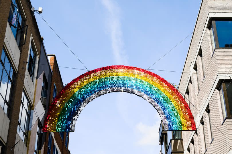 A rainbow banner over a road in Soho