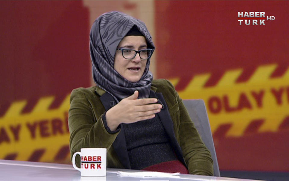 In this image from TV, Hatice Cengiz, who is Turkish, reacts during an interview on Turkish television channel HaberTurk, Friday Oct. 26, 2018, about the day her fiancee Saudi writer Jamal Khashoggi entered the Saudi Arabia Consulate on Oct. 2, and was killed inside. Hatice Cengiz said "I found myself in a darkness I cannot express", and talked about when Khashoggi had gone to the consulate for paperwork related to his planned marriage to Cengiz. (HaberTurk TV via AP)