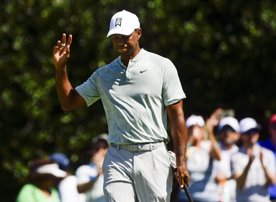 Tiger Woods acknowledges the gallery after making a birdie putt on the second green during the second round of the Tour Championship golf tournament Friday, Sept. 21, 2018, in Atlanta. (AP Photo/John Amis)