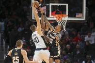 Los Angeles Clippers center Ivica Zubac (40) is defended by Atlanta Hawks forward John Collins (20) in the first half of an NBA basketball game Wednesday, Jan. 22, 2020, in Atlanta, Ga. (AP Photo/Brett Davis)