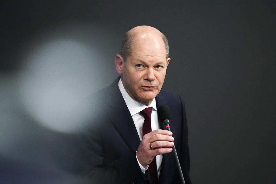 German Chancellor Olaf Scholz answers questions about mandatory vaccination from a lawmaker during a session of the Parliament Bundestag in Berlin, Germany, Wednesday, Jan. 12, 2022. (AP Photo/Markus Schreiber)