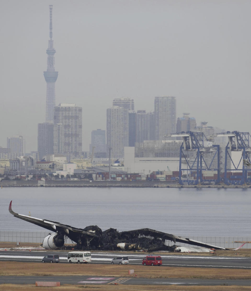 The burn-out wreckage of Japan Airlines plane is seen at Haneda airport on Wednesday, Jan. 3, 2024, in Tokyo, Japan. The large passenger plane and a Japanese coast guard aircraft collided on the runway at Tokyo's Haneda Airport on Tuesday and burst into flames, killing several people aboard the coast guard plane, officials said. (Kyodo News via AP)