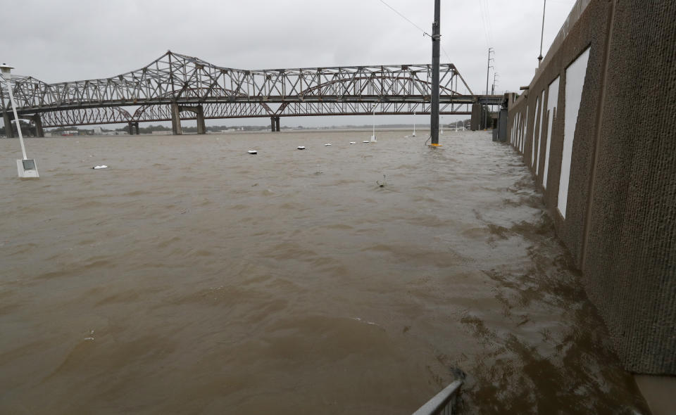 As the Atchafalaya River continues to rise due to the rains of Tropical Storm Barry, it becomes harder to see the Morgan City name on the sea wall, Saturday, July 13, 2019 in Morgan City, La. (AP Photo/Rogelio V. Solis)