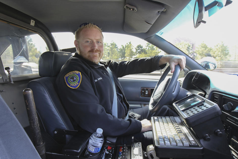 This Nov. 21, 2020 shows Houston police officer Jason Knox in a restored HPD cruiser in Houston. The Houston police department tweeted that Knox, a Tactical Flight Officer, was killed when a police helicopter crashed early Saturday, May 2, 2020 in Houston. (Steve Gonzales/Houston Chronicle via AP)