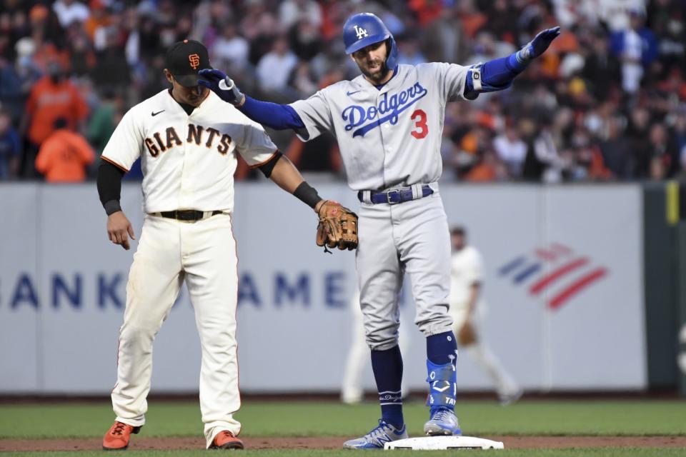 Dodgers' Chris Taylor, right, reacts after reaching second on a double.