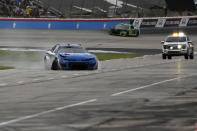 Kyle Larson (5) limps into pit row after crashing in Turn 4 during the NASCAR All-Star auto race at Texas Motor Speedway in Fort Worth, Texas, Sunday, May 22, 2022. (AP Photo/Randy Holt)