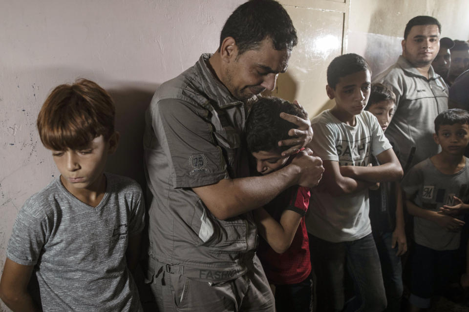 Relatives of Palestinian Omar al-Nile, 12, who was shot on Saturday during a violent demonstration on the eastern border between Gaza and Israel, react during his funeral in the family home in Gaza City, Saturday, Aug. 28, 2021. (AP Photo/Khalil Hamra)