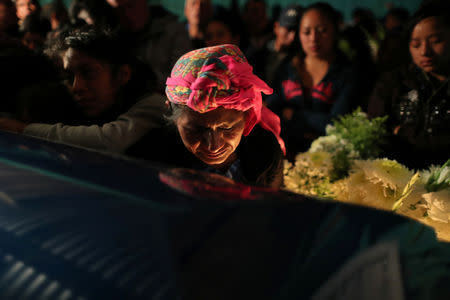 Eulalia Paiz, 54, mourns her son Misael Paiz, 25, as his coffin lies inside his family home at a wake in Aguacate, Huehuetenango, Guatemala, October 28, 2018. REUTERS/Lucy Nicholson
