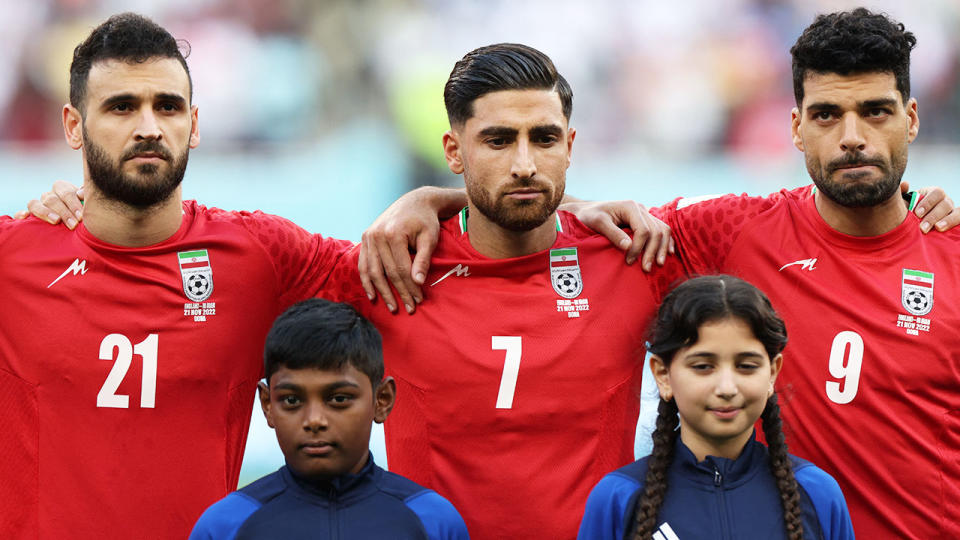 Iranian players Ahmad Noorollahi, Alireza Jahanbakhsh and Mehdi Taremi are pictured during the national anthem.