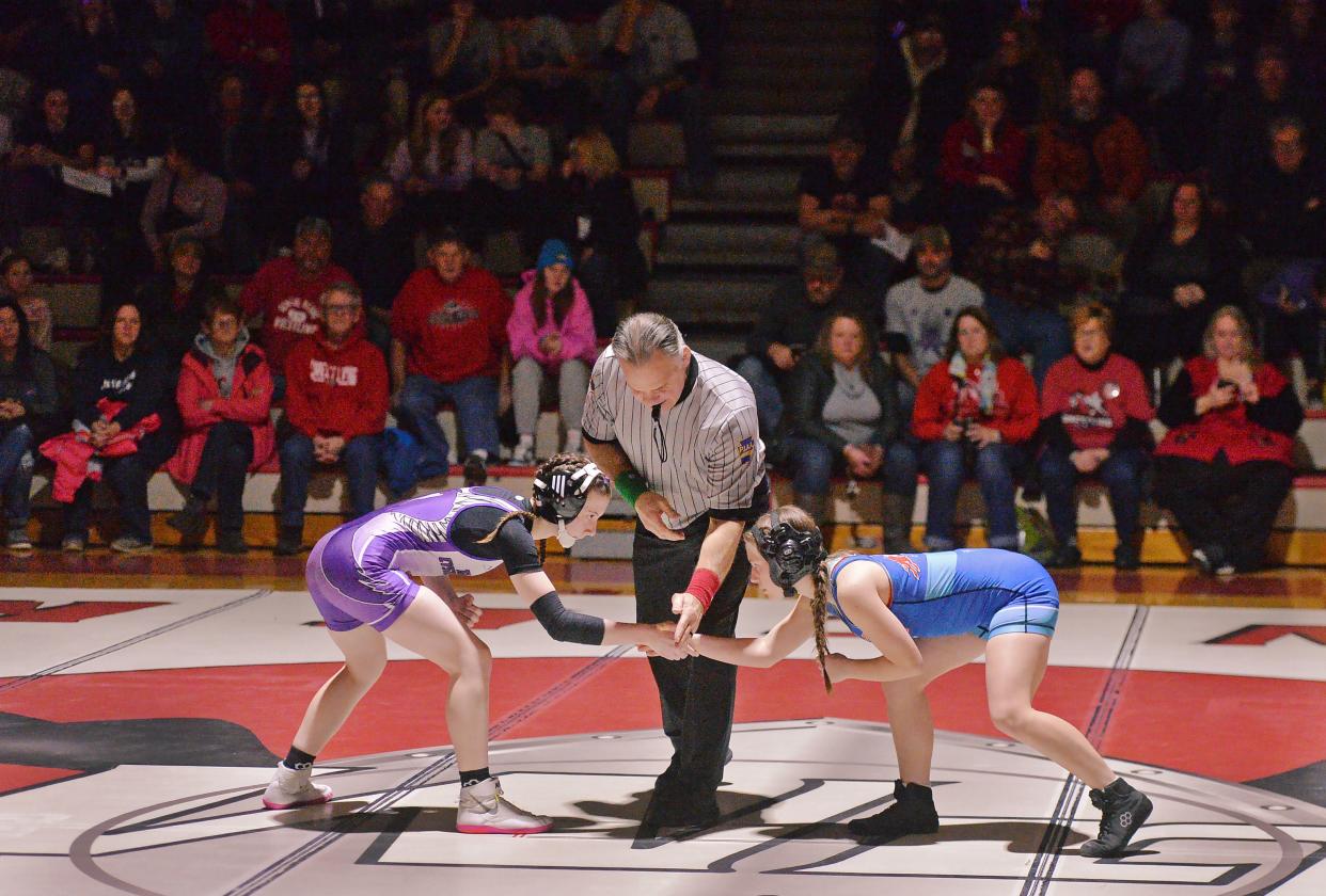 General McLane High School's Ella Clark, left, and Fort LeBoeuf's Hayden Ramey get set to wrestle at 106 pounds during the first District 10 girls team dual meet in Washington Township on Jan. 17, 2024.