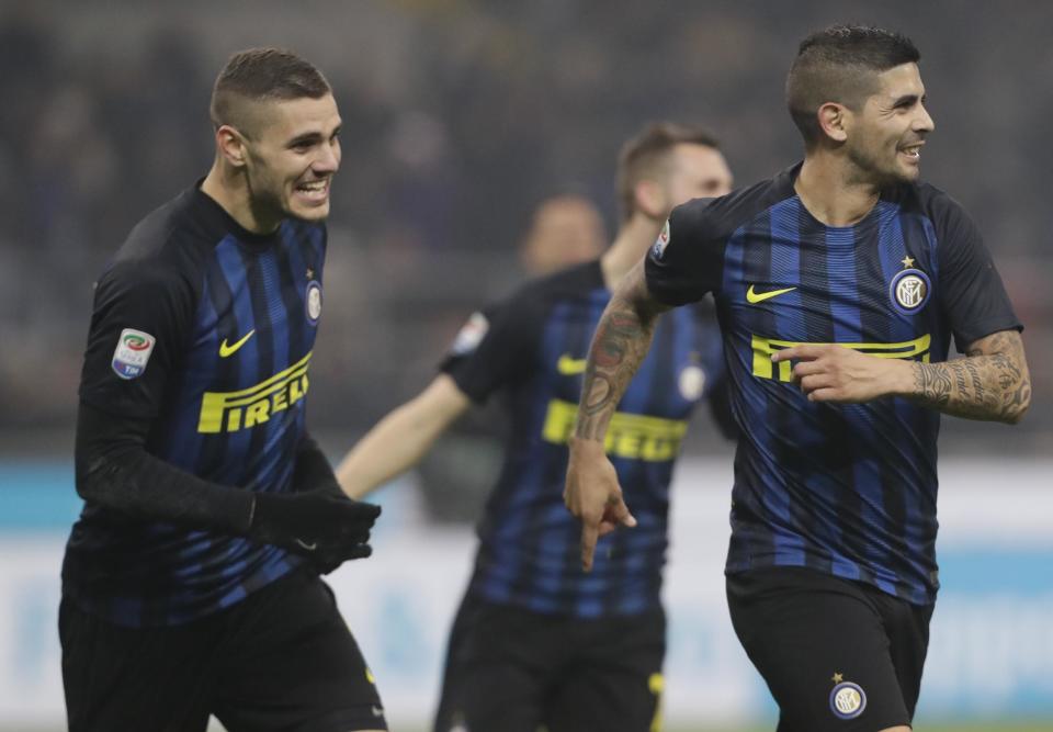 Inter Milan's Ever Banega, right, celebrates with teammate Mauro Icardi after scoring during a Serie A soccer match between Inter Milan and Lazio, at the San Siro stadium in Milan, Italy, Wednesday, Dec. 21, 2016. (AP Photo/Luca Bruno)