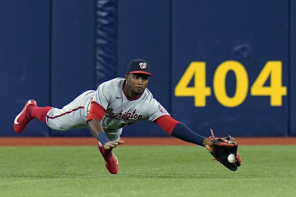 Washington Nationals center fielder Victor Robles can't make the catch on a single by Tampa Bay Rays' Randy Arozarena during the third inning of a baseball game Wednesday, June 9, 2021, in St. Petersburg, Fla. (AP Photo/Chris O'Meara)