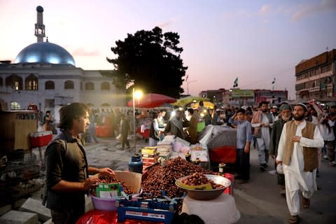 People shop at a market in the Old City of Kabul, Afghanistan, Sunday, Sept. 8, 2019 - Credit: &nbsp;Ebrahim Noroozi/AP