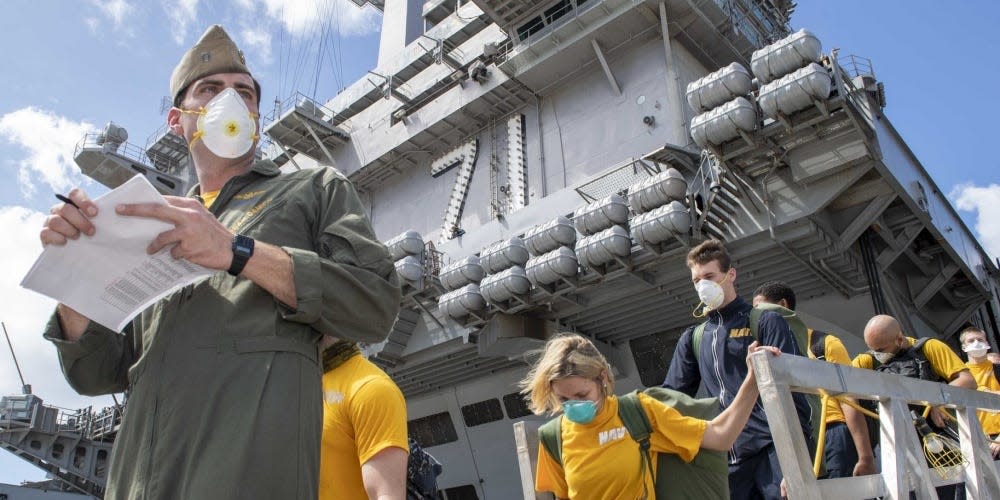 U.S. Sailors assigned to the aircraft carrier USS Theodore Roosevelt (CVN 71) depart the ship to move to off-ship berthing April 10, 2020