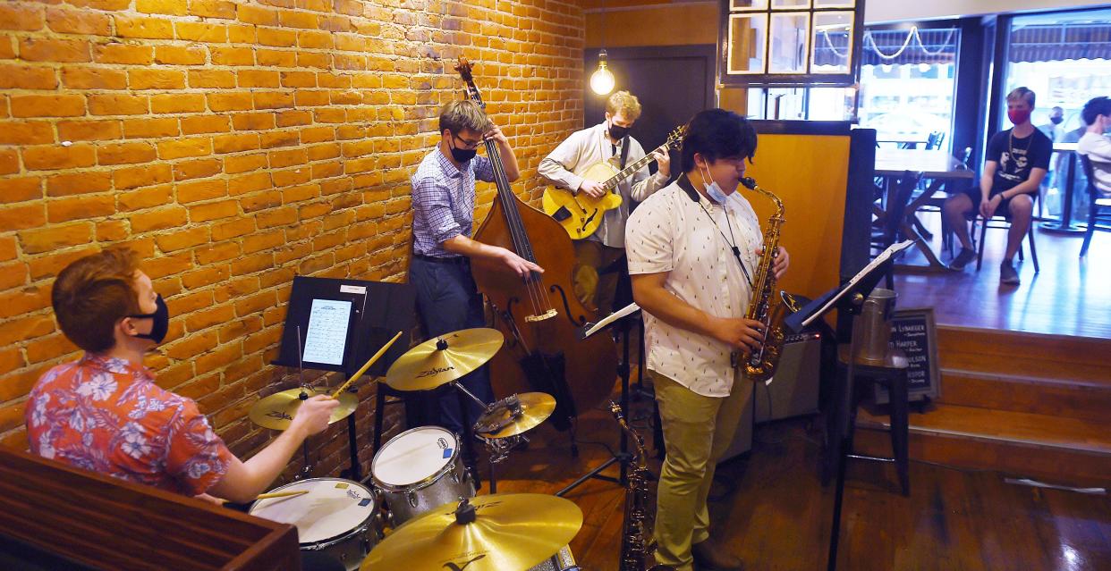 Members of the David Harper Quartet band (from left) Quinton Neapor, Spencer Paulson, David Harper and Hudson Lybarger perform at Cafe Diem in downtown Ames during the Music Walk Thursday, April 29, 2021, in Ames, Iowa.