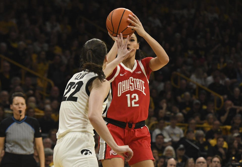 Ohio State guard Celeste Taylor (12) attempts a basket while under pressure from Iowa guard Caitlin Clark (22) during the first half of an NCAA college basketball game, Sunday, March 3, 2024, in Iowa City, Iowa. (AP Photo/Cliff Jette)