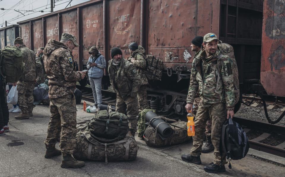 Ukrainian soldiers wait for a train to Odesa, at the Kramatorsk Train Station - Anadolu Agency/Anadolu