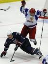 Russia's Valentin Zykov (R) checks Steven Santini of the U.S. during the first period of their quarter-final game at the IIHF World Junior Championship ice hockey game in Malmo, Sweden, January 2, 2014. REUTERS/Alexander Demianchuk (SWEDEN - Tags: SPORT ICE HOCKEY)