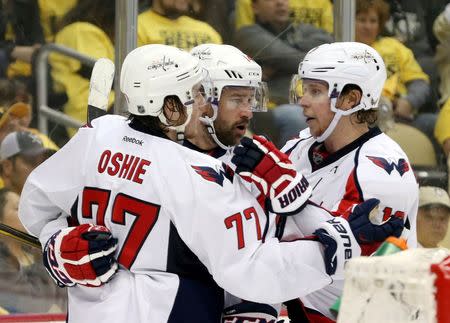 Washington Capitals right wing Justin Williams (middle) celebrates his goall with right wing T.J. Oshie (77) and center Nicklas Backstrom (R) against the Pittsburgh Penguins during the third period in game three of the second round of the 2016 Stanley Cup Playoffs at the CONSOL Energy Center. The Pens won 3-2. Mandatory Credit: Charles LeClaire-USA TODAY Sports