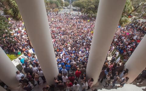 Protesters rally against gun violence on the steps of the old Florida Capitol in Tallahassee - Credit:  Mark Wallheiser/AP