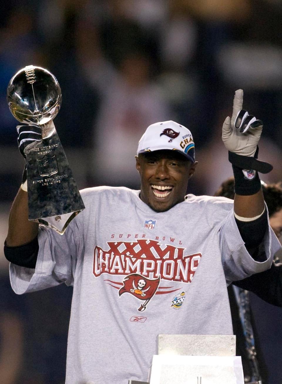 Jan 26, 2003; San Diego, CA, USA; FILE PHOTO; Tampa Bay Buccaneers defensive back Dexter Jackson celebrates with the Vince Lombardi trophy after defeating the Oakland Raiders in Super Bowl XXXVII at Qualcomm Stadium. The Bucs defeated the Raiders 48-21. Mandatory Credit: USA TODAY Sports