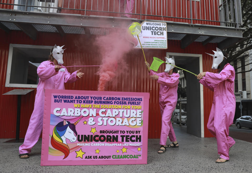 Members of Extinction Rebellion stage a protest in Cape Town, South Africa, Friday, Nov. 11, 2022 to mark COP27's "Decarbonization Day". The protest was held to highlight greenhouse gas emissions caused by the use of fossil fuels. (AP Photo/Nardus Engelbrecht)