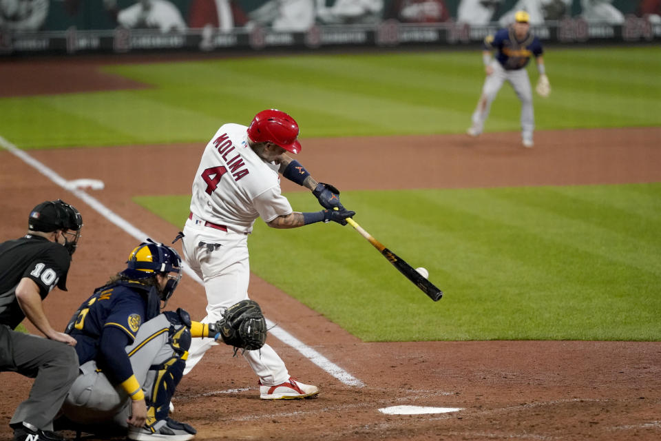 St. Louis Cardinals' Yadier Molina singles for his 2,000th career hit during the seventh inning of a baseball game against the Milwaukee Brewers Thursday, Sept. 24, 2020, in St. Louis. (AP Photo/Jeff Roberson)