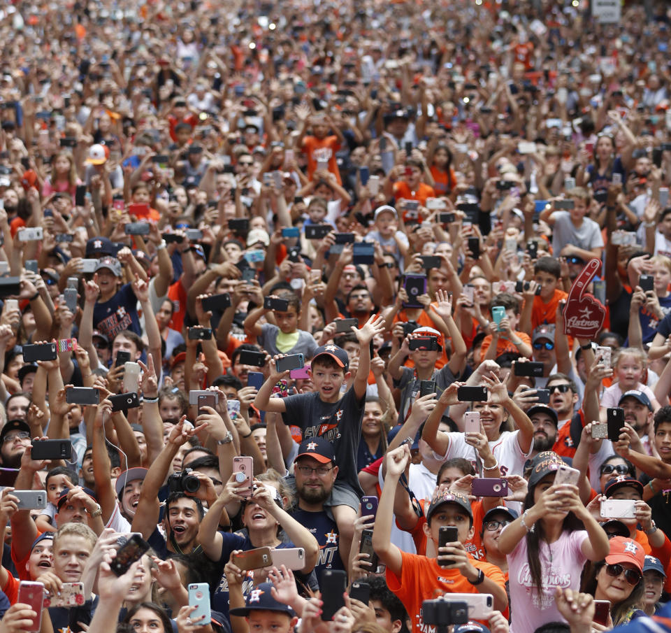 Houston Astros fans celebrate during a parade honoring the World Series baseball champions, Friday, Nov. 3, 2017, in Houston. (Karen Warren/Houston Chronicle via AP)