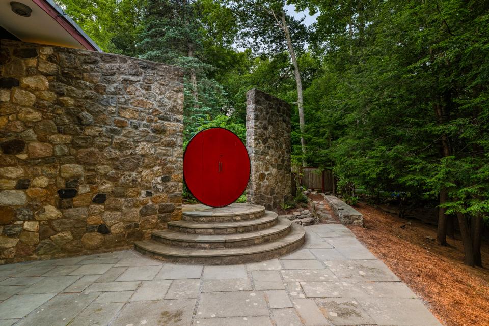 Throughout the 7.5-acre property are outdoor elements that add pops of red, like this moon gate.