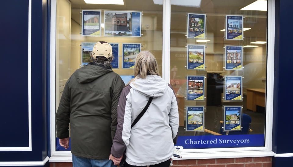 LEEK, ENGLAND - NOVEMBER 11: A couple are seen looking at houses for sale at an estate agents in Market Town of Leek on November 11, 2020 in Leek, England. The United Kingdom will continue to impose lockdown measures until December 2 in an attempt to curb transmissions of the coronavirus (COVID-19)   (Photo by Nathan Stirk/Getty Images)