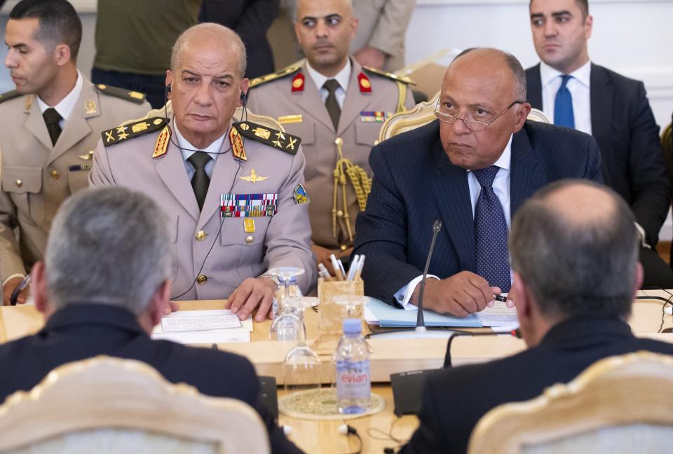 Russian Foreign Minister Sergey Lavrov, right back to a camera, and Russian Defense Minister Sergei Shoigu, left back to camera, attend the talks with Egyptian Foreign Minister Sameh Shoukry, right, and Egyptian Defense Minister Mohamed Zaki, left, during their meeting in Moscow, Russia, Monday, June 24, 2019. Egyptian President Abdel-Fattah el-Sissi has moved to increase military cooperation with Russia, and the two nation‚ascforeign and defense ministers have held regular meetings. (AP Photo/Alexander Zemlianichenko)