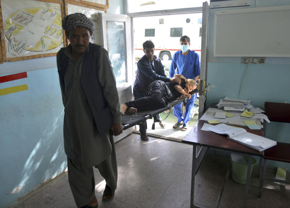 In this Sunday, Aug. 12, 2018, photo, a wounded woman is brought into a hospital in Ghazni province, west of Kabul, Afghanistan. The United States has sent military advisers to aid Afghan forces in Ghazni, where they were struggling on Sunday to regain full control three days after the Taliban launched a massive assault on the eastern city. (AP Photo/Mohammad Anwar Danishyar)