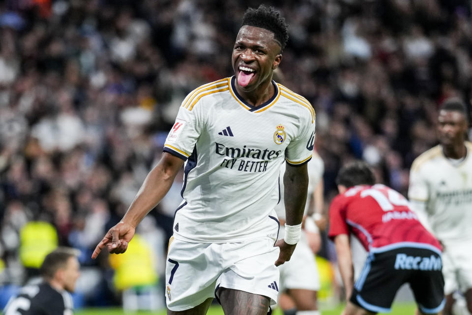 Real Madrid's Vinicius Junior celebrates after scoring his side's first goal during a Spanish La Liga soccer match between Real Madrid and Celta Vigo at the Santiago Bernabeu stadium in Madrid, Spain, Sunday, March 10, 2024. (AP Photo/Manu Fernandez)