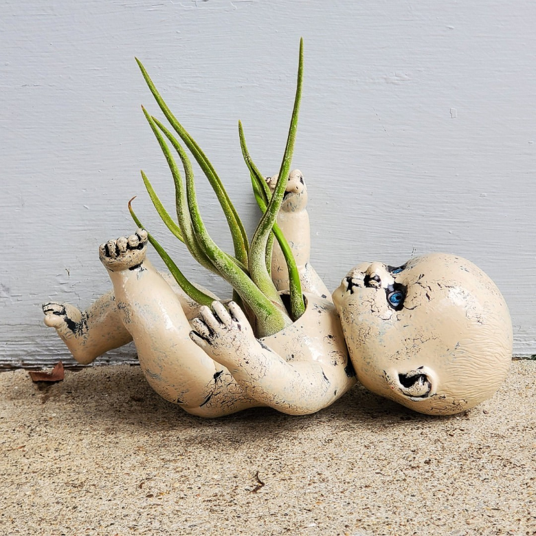 Hand sculpted baby planter by Althea's Lair.