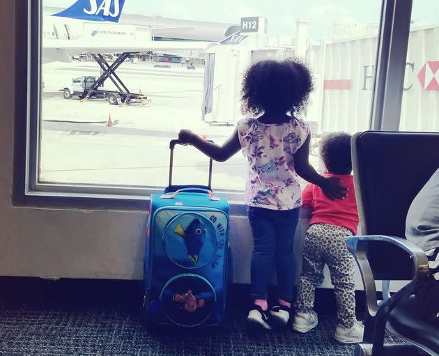 Monet Hambrick's children wait to board their flight.